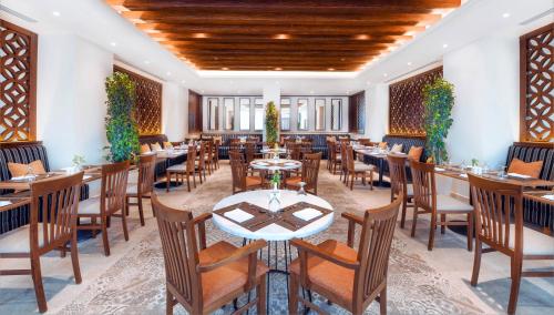 a restaurant with tables and chairs in a room at JAZ Elite Casa Del Mar Beach in Hurghada