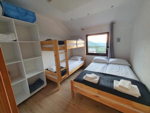 a bedroom with two bunk beds and a window at Jelka apartmani in Jahorina