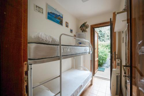 a room with two bunk beds and a doorway at 3 bedrooms house at Sabaudia 800 m away from the beach with lake view and enclosed garden in Sabaudia