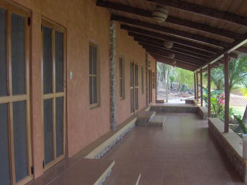 an empty hallway of a building with a porch at Hotel Bahia Taitza in Flores