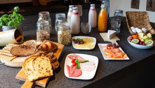 a table with different types of bread and other foods at Brabantse Hoeve in Volkel
