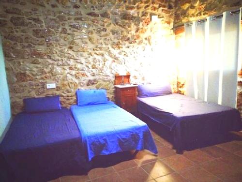 Ένα ή περισσότερα κρεβάτια σε δωμάτιο στο 6 bedrooms villa with private pool enclosed garden and wifi at La Salzadella