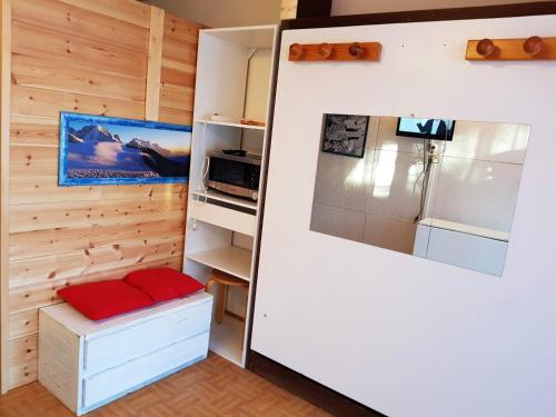 a kitchen with wooden walls and a refrigerator at Studio avec balcon amenage et wifi a Vars in Vars