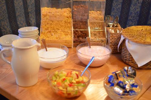 a wooden table topped with bowls of food on a counter at Gasthof Zum Lendwirt in Westendorf