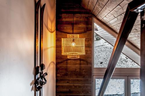a view from the inside of a house with a window at Appartement spacieux L'Alpe d'Huez, balcon in LʼHuez