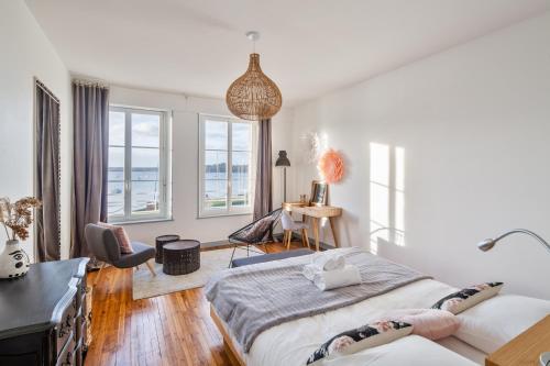 a bedroom with two beds and a desk at Le Zénith - avec vue mer in Saint Malo