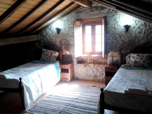 a bedroom with two beds and a window at Charming house in Alcobaça with mountain view in Alcobaça