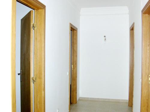 an empty room with two doors and a hallway at Charming house in Alcobaça with mountain view in Alcobaça