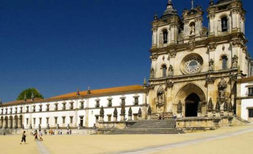 a large building with a clock tower on top of it at Charming house in Alcobaça with mountain view in Alcobaça