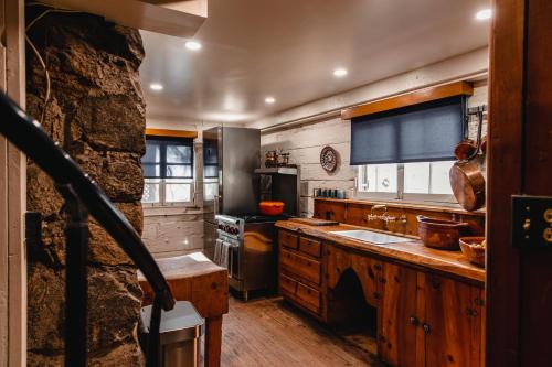 a kitchen with wooden counters and a stone wall at The Fireside Inn in Idyllwild