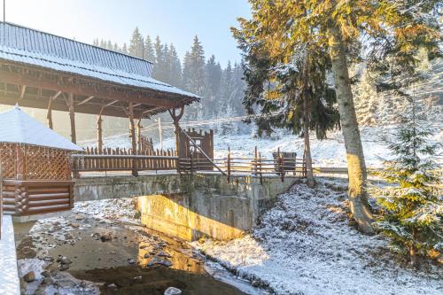 a bridge with a gazebo in the snow at Villa Nikoletta SPA in Bukovel