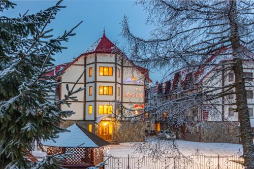 a building in the snow at night at Villa Nikoletta SPA in Bukovel