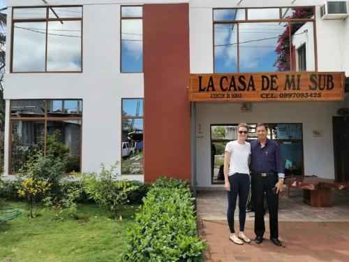 two women standing in front of a building at La Casa De Mi Sub in Puerto Baquerizo Moreno