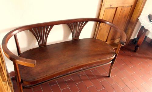 a wooden chair sitting next to a wall at Pension Plešivecká 119 in Český Krumlov