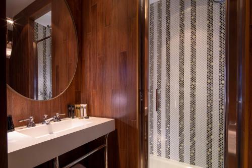 a bathroom with a sink and a mirror at Hotel Maison FL in Paris