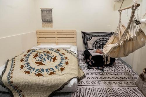 a bedroom with a bed and a hammock at Daily Home in Xiaoliuqiu