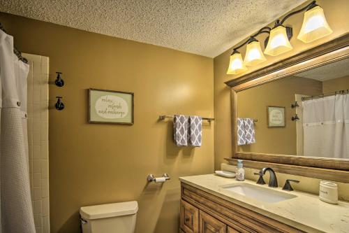 a bathroom with a sink and a mirror and a toilet at Cozy Bellaire Condo with Balcony - 3 Mi to Skiing! in Bellaire