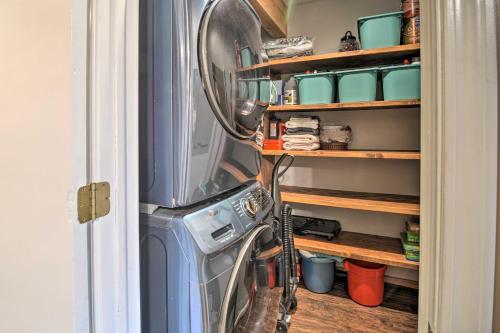 a washer and dryer in a kitchen next to a door at Cozy Bellaire Condo with Balcony - 3 Mi to Skiing! in Bellaire