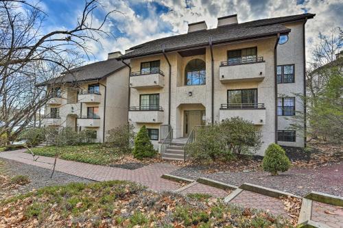 a large building with a driveway in front of it at On Big Boulder Lake Condo with Community Pools! in Lake Harmony