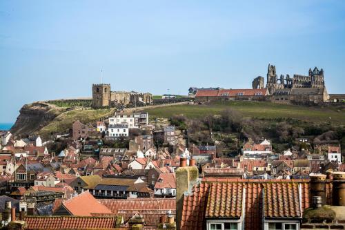 a city with a castle on top of a hill at The Resolution Hotel in Whitby