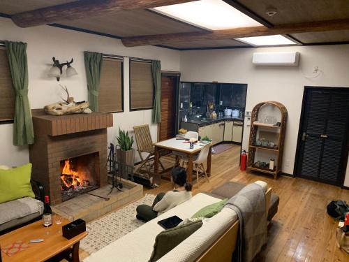 a living room with a couch and a fireplace at Holyday House Nagata - Vacation STAY 07980v in Nagata