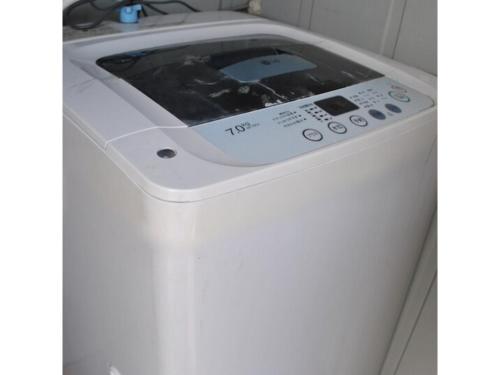a washing machine in the corner of a bathroom at Hotel Suntargas Otsuka - Vacation STAY 08520v in Tokyo