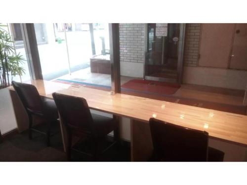 a large wooden table with chairs in a room at Hotel Suntargas Otsuka - Vacation STAY 08520v in Tokyo