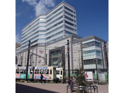 a large building with a bus in front of it at Hotel Suntargas Otsuka - Vacation STAY 08494v in Tokyo