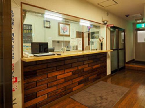 a bar in a restaurant with a brick wall at Urbanty Nishikujo - Vacation STAY 08577v in Osaka