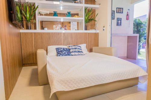 a bedroom with a bed with two pillows on it at Solar Agua in Pipa