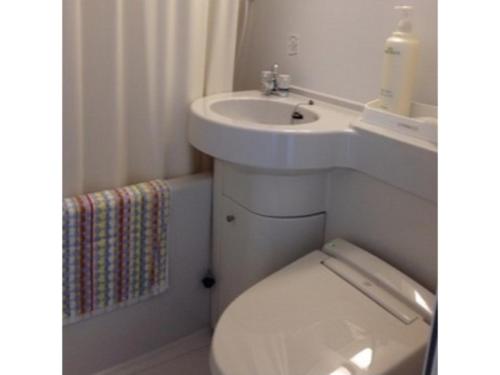 a bathroom with a white sink and a toilet at Urbanty Nishikujo - Vacation STAY 08584v in Osaka