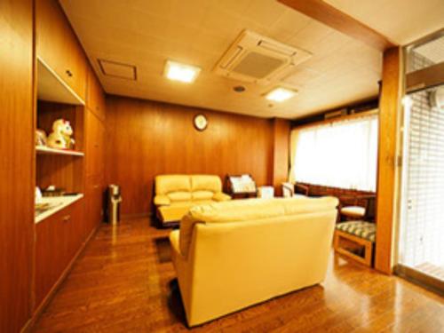 a living room with a couch and a table at Urbanty Nishikujo - Vacation STAY 08584v in Osaka