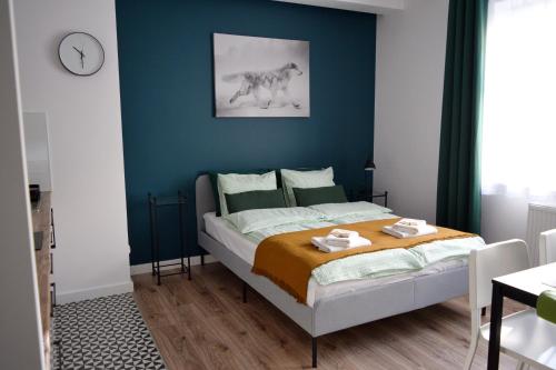 クリニツァ・ズドルイにあるForRest Apartment Krynicaの青い壁のベッドルーム1室