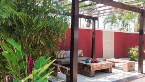 a patio with a bench and a table at Pousada Tartaruga in Búzios