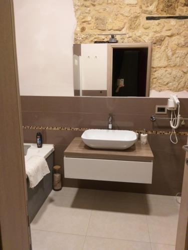 a bathroom with a sink and a mirror at Al Castello in Cagliari