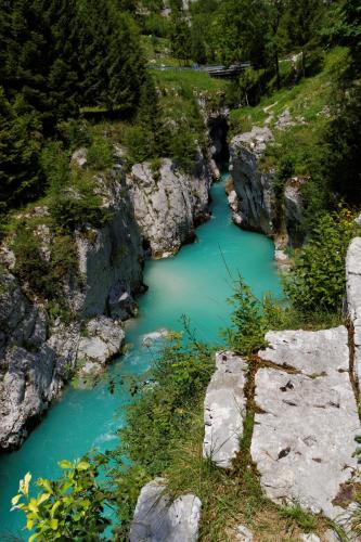 a river with blue water in a rocky canyon at Hotel Alp in Bovec