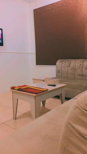 a coffee table in a living room with a couch at Al Beagy Furnished Units in Hafr Al Baten