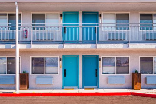 a building with blue doors in front of a building at voco The Tuxon by IHG in Tucson