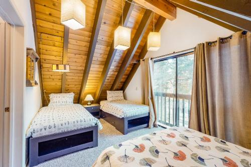 two beds in a room with a window at Hillside Haven in Soda Springs