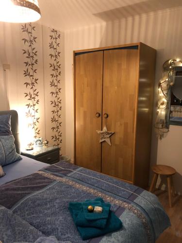 a bedroom with a bed with a wooden cabinet at Haus Zissi in Burg-Reuland