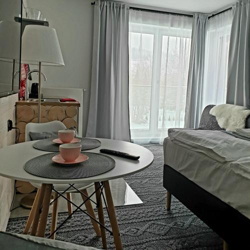 a room with a coffee table and a bed at Villa Olimpijska 2 - Centrum in Wisła