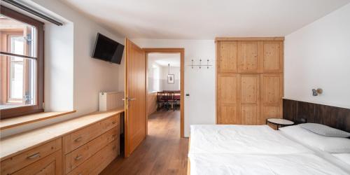 a bedroom with a bed and a window and a table at Apartment Cesa Collina Family in Ortisei