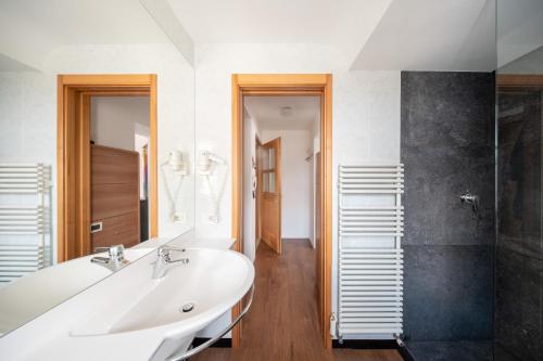 a bathroom with a white sink and a shower at Apartment Cesa Collina in Ortisei