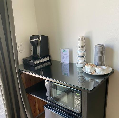 a counter with a coffee maker and a microwave at Hollywood’s Suite in Los Angeles