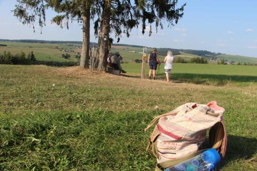 a group of people in a field with a bag on the grass at Haus Zissi in Burg-Reuland