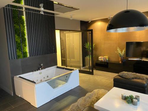 a large bathroom with a jacuzzi tub at MagSpace River View Jacuzzi Apartment in Gdańsk