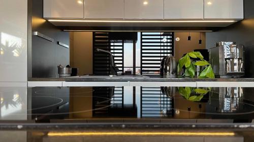 a kitchen with a sink and a counter top at MagSpace River View Jacuzzi Apartment in Gdańsk