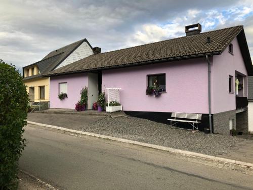 a pink house on the side of a street at Haus Zissi in Burg-Reuland