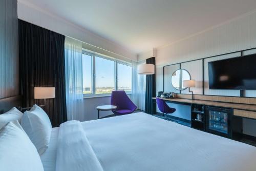 a hotel room with a large bed and a television at Radisson Blu Hotel Amsterdam Airport, Schiphol in Schiphol