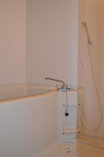 a shower in a bathroom with a bath tub at Gracias in Kagoshima